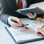 Businessman,And,Lawyer,Discuss,The,Contract,Document.,Treaty,Of,The